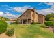 Expansive backyard featuring lush lawn, mature trees, and covered patio, perfect for outdoor entertaining at 7460 E Kiowa Ave, Mesa, AZ 85209