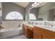 Bright bathroom with dual sinks and tub at 7460 E Kiowa Ave, Mesa, AZ 85209