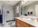 An elegant bathroom features a double sink vanity, a spacious tiled shower, and a toilet in a well-lit space at 7460 E Kiowa Ave, Mesa, AZ 85209