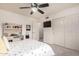 This bedroom features a ceiling fan, sliding door closet, and desk space, perfect for a comfortable and functional living area at 7460 E Kiowa Ave, Mesa, AZ 85209