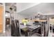 Open-concept dining room with a wooden table and staircase at 7460 E Kiowa Ave, Mesa, AZ 85209