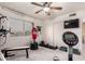 Spacious home gym featuring multiple workout machines, a television, and a set of dumbbell weights at 7460 E Kiowa Ave, Mesa, AZ 85209