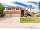 Two-story home featuring a well-manicured lawn and three-car garage at 7460 E Kiowa Ave, Mesa, AZ 85209