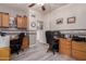 A home office featuring dual workstations, custom cabinetry, and nautical-themed decor, perfect for a productive workspace at 7460 E Kiowa Ave, Mesa, AZ 85209