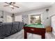 Spacious bonus room including a pool table and couch for relaxing at 7460 E Kiowa Ave, Mesa, AZ 85209
