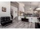 Open-concept living area with staircase, stylish flooring and neutral color palette at 7460 E Kiowa Ave, Mesa, AZ 85209