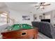 Spacious bonus room including a pool table and couch for relaxing at 7460 E Kiowa Ave, Mesa, AZ 85209
