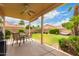 Enjoy outdoor dining on the covered patio with ceiling fan and views of the landscaped backyard at 7460 E Kiowa Ave, Mesa, AZ 85209