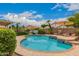 Beautiful pool area complete with lounge chairs and an umbrella table, ideal for relaxation at 7460 E Kiowa Ave, Mesa, AZ 85209