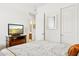 Bright bedroom with TV, closet, and bathroom access at 7587 W Quail Ave, Glendale, AZ 85308