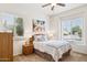 Bedroom showcasing large windows, ceiling fan, and coastal-inspired decor at 7587 W Quail Ave, Glendale, AZ 85308