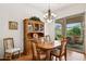 Bright dining room with a wooden table, decorative chandelier, and view to the backyard patio at 7587 W Quail Ave, Glendale, AZ 85308