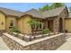 Close up of the exterior featuring desert landscaping, paver sidewalk, and stone accent columns at 7587 W Quail Ave, Glendale, AZ 85308
