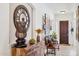 Inviting foyer with decoratively adorned console table and bench seating at 7587 W Quail Ave, Glendale, AZ 85308