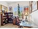 Inviting home office featuring a desk, bookcase, and large window providing natural light and space for productivity at 7587 W Quail Ave, Glendale, AZ 85308