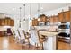 Kitchen with granite counters, barstool seating, and custom cabinets at 7587 W Quail Ave, Glendale, AZ 85308
