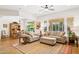 Open-concept living room with hardwood floors, large windows, and comfortable furnishings at 7587 W Quail Ave, Glendale, AZ 85308