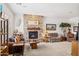 Cozy living room featuring a stone fireplace, neutral carpet, and comfortable seating at 7587 W Quail Ave, Glendale, AZ 85308