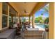 Covered patio space with cozy seating, overlooking a pool, perfect for enjoying the outdoors at 7587 W Quail Ave, Glendale, AZ 85308