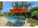 Resort-style pool with a built-in waterfall feature and vibrant tropical landscaping for ultimate relaxation at 7587 W Quail Ave, Glendale, AZ 85308