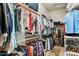 Walk-in closet features extensive storage for clothing and shoes with racks and shelving at 7587 W Quail Ave, Glendale, AZ 85308