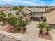 Aerial view of a two-story home with a well-maintained front yard, mature landscaping, and surrounding community at 8214 S 48Th Dr, Laveen, AZ 85339