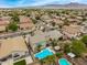 This aerial view displays the backyard that features mature landscaping, a pool, and easy access to nearby amenities at 8214 S 48Th Dr, Laveen, AZ 85339