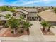 Aerial view of a two-story home with a well-maintained front yard, mature landscaping, and surrounding community at 8214 S 48Th Dr, Laveen, AZ 85339