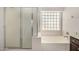 Bright bathroom features a standalone shower and tub, offering comfort and convenience at 8214 S 48Th Dr, Laveen, AZ 85339