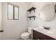 Bathroom features a window for natural light and stylish floating shelves at 8214 S 48Th Dr, Laveen, AZ 85339