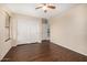 Bedroom features a fan, and closet with sliding doors, and flows to additional rooms at 8214 S 48Th Dr, Laveen, AZ 85339