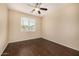 Relaxing bedroom with a window, ceiling fan, and attractive wood-look floors at 8214 S 48Th Dr, Laveen, AZ 85339