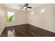 Bright bedroom with ceiling fan and wood floors. Natural light from the two windows at 8214 S 48Th Dr, Laveen, AZ 85339