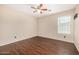Cozy bedroom with a ceiling fan and a sunlit window with blinds at 8214 S 48Th Dr, Laveen, AZ 85339