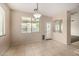 Bright dining area with a view of the pool is illuminated by a modern light fixture at 8214 S 48Th Dr, Laveen, AZ 85339