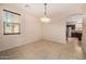 Cozy dining room boasts a chandelier and a window, creating a welcoming atmosphere at 8214 S 48Th Dr, Laveen, AZ 85339