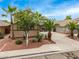 Two-story home with a well-maintained front yard with mature landscaping and palm trees at 8214 S 48Th Dr, Laveen, AZ 85339