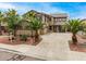 Two-story home with a well-maintained front yard with mature landscaping and palm trees at 8214 S 48Th Dr, Laveen, AZ 85339