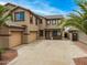 Two-story home with a three car garage and a well-maintained front yard at 8214 S 48Th Dr, Laveen, AZ 85339