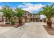 Two-story home featuring a spacious concrete driveway, desert landscaping, and a two-car garage at 8214 S 48Th Dr, Laveen, AZ 85339