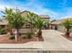 Two-story home with a well-maintained front yard with mature landscaping and palm trees at 8214 S 48Th Dr, Laveen, AZ 85339
