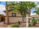 Side view of a two-story home featuring manicured landscaping, and mature trees at 8214 S 48Th Dr, Laveen, AZ 85339