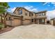 Two-story home featuring an attached three-car garage and large driveway at 8214 S 48Th Dr, Laveen, AZ 85339
