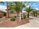 Home's front yard with decorative rock landscaping and mature trees with a long driveway at 8214 S 48Th Dr, Laveen, AZ 85339