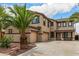 Two-story home featuring an attached three-car garage and covered front porch area at 8214 S 48Th Dr, Laveen, AZ 85339