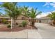 Two-story home featuring manicured landscaping, a long driveway and attached two car garage at 8214 S 48Th Dr, Laveen, AZ 85339