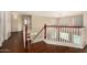 Bright hallway with hardwood floors, white walls and railing looking down to first floor at 8214 S 48Th Dr, Laveen, AZ 85339