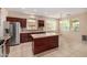 Modern kitchen features stainless appliances, rich wood cabinets, an island, and natural light at 8214 S 48Th Dr, Laveen, AZ 85339