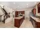 Gourmet kitchen has an island, stainless appliances, rich wood cabinetry, and recessed lighting at 8214 S 48Th Dr, Laveen, AZ 85339