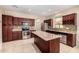 Spacious kitchen with tile flooring, an island, stainless appliances, and wood cabinets at 8214 S 48Th Dr, Laveen, AZ 85339